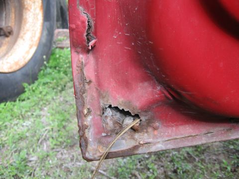 1974 Ford F-100 - The lower corner of a 1974 Ford F-100 door shows extensive rust and holes.