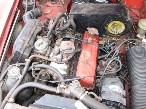 1974 Ford F-100 - Close-up view of a vehicle's engine bay, showing various components and wiring.
