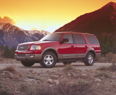 2003 Ford Expedition - A red 2003 Ford Expedition is parked in a rocky, mountainous landscape during sunset.