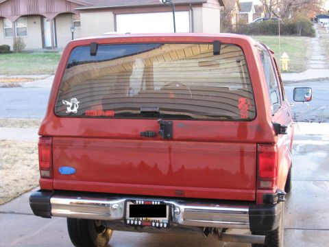 1984 Ford Bronco II - Rear view of a red 1984 Ford Bronco II, showing its tailgate and bumper.