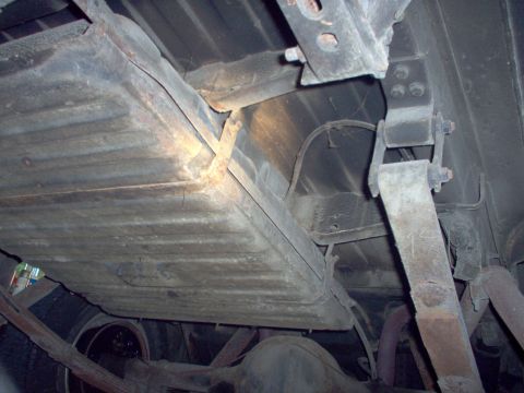 1970 Ford Ranchero - This photo shows the undercarriage of a vehicle, focusing on the fuel tank and suspension components.