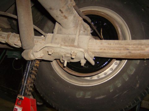 1970 Ford Ranchero - Close-up view of the rear suspension and tire assembly of a vehicle.
