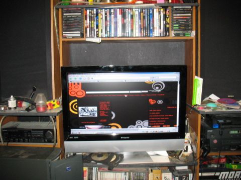 1997 Ford Crown Victoria - A computer monitor displays a website with a dark background and colorful graphic elements.