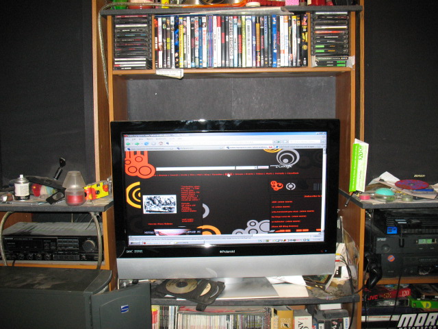 Computer monitor showing a website with abstract orange and black graphics