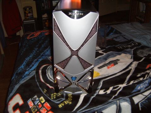 1993 Ford Bronco - A silver computer tower with a distinctive X design is shown on a blanket with racing graphics.