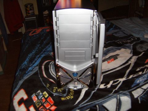 1993 Ford Bronco - A silver computer tower is shown with its front panel open, revealing internal components and a blue emblem on the lower section.