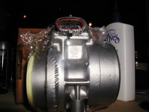 1992 Ford Taurus - Mass air flow sensor, likely new, with 'Japan' stamped on its housing.