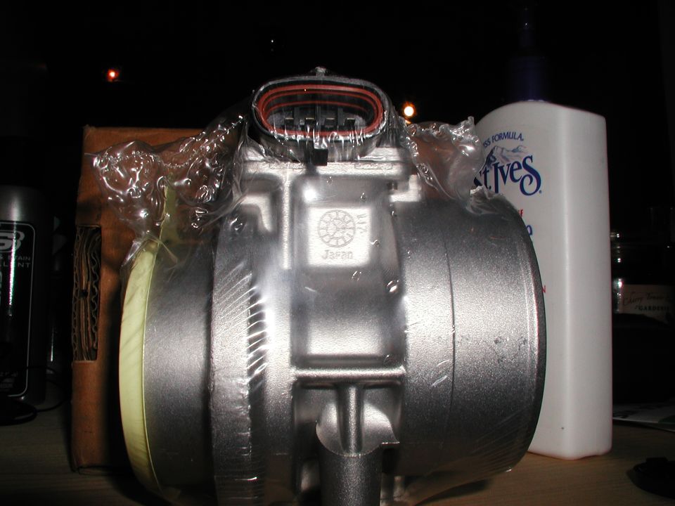 New mass air flow sensor in plastic wrap, with 'Japan' marking visible
