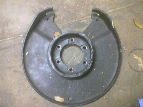 1989 Ford Bronco - Dust shield for a vehicle's brake rotor, likely for a Ford Bronco.