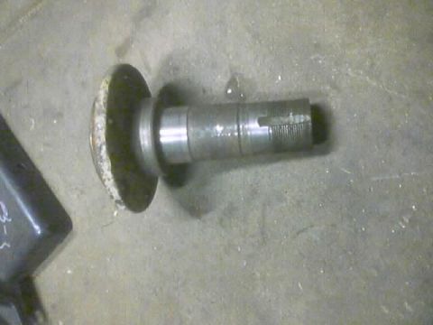 1989 Ford Bronco - Close-up of a metal axle part with a flange and splined end.