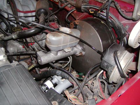 1991 Ford Bronco - Close-up view of engine bay components, including the brake booster and master cylinder.