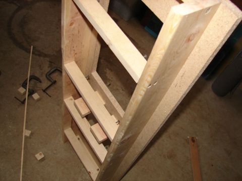 1996 Ford Bronco - Construction of a wooden shelving unit is underway, with various pieces of wood and clamps visible.