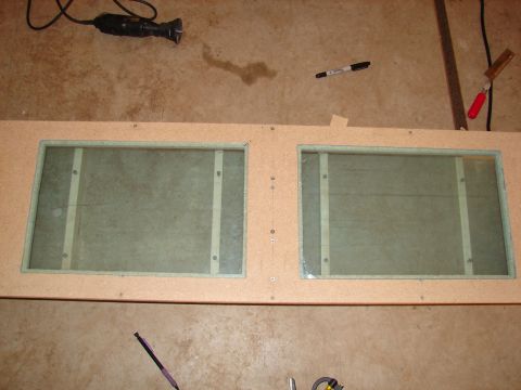 1996 Ford Bronco - A wooden enclosure with two glass panels and tools is shown, unrelated to a 1996 Ford Bronco stereo system.