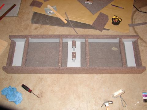 1996 Ford Bronco - A custom speaker enclosure is shown with tools and materials for installation scattered around.