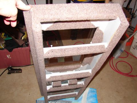 1996 Ford Bronco - Custom speaker enclosure being worked on, showing internal structure and carpeted exterior.
