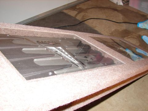 1996 Ford Bronco - A KICKER amplifier is installed in a custom carpeted enclosure, suggesting an aftermarket audio system.