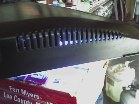 1993 Ford C-350 (Centurion Conversions) - A black canopy with illuminated blue vents sits atop a box with text indicating it's from Fort Myers-Lee County.