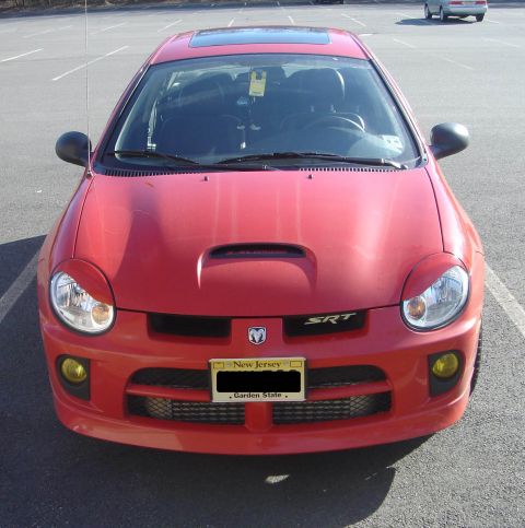 2005 Dodge SRT-4 - Front view of a red 2005 Dodge SRT-4 parked in a lot, displaying its distinctive hood scoop and SRT badging.
