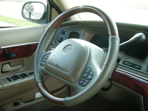 2000 Mercury Grand Marquis - Interior view of a 2000 Mercury Grand Marquis, focusing on the steering wheel and driver's side controls.