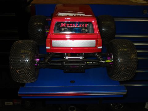 1994 Ford Bronco - This remote-controlled truck has a red body and large off-road tires, with custom text on the rear window.