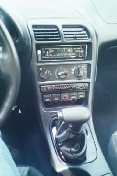 1994 Ford Probe - The interior of a 1994 Ford Probe, the center console with radio and automatic transmission shifter.