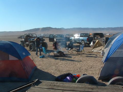 1994 Jeep YJ - A 1994 Jeep YJ is parked at a desert campsite alongside tents and other vehicles.