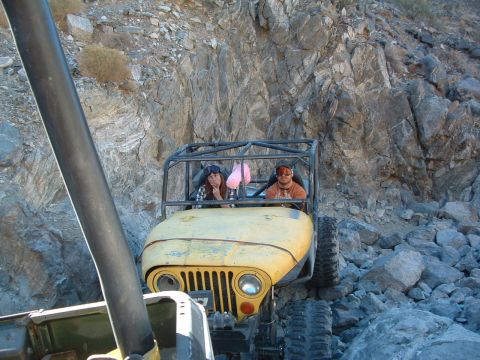 1994 Jeep YJ - Two people ride in a modified Jeep as it navigates a rocky, off-road trail.