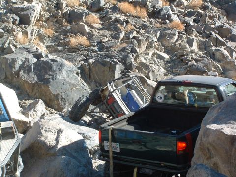 1994 Jeep YJ - Two vehicles navigate a rocky, off-road terrain, with one vehicle overturned.