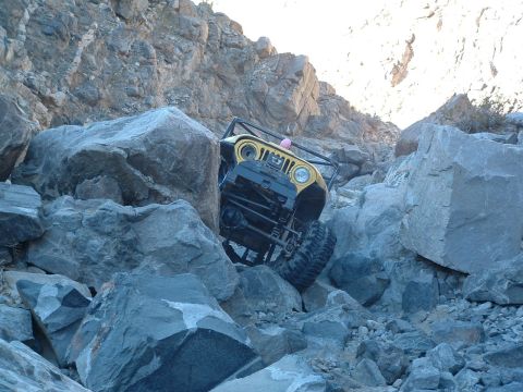 1994 Jeep YJ - Jeep YJ tackling a challenging rock crawl, demonstrating its off-road capability.