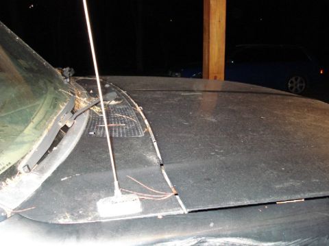 1989 Ford F-250 - Close-up of a vehicle's hood and windshield, with another car in the background.