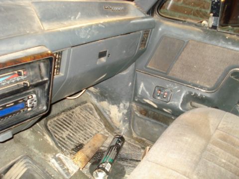 1989 Ford F-250 - The interior of a 1989 Ford F-250 shows a dusty dashboard, aftermarket radio, and worn seats.