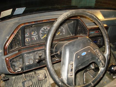 1989 Ford F-250 - Interior view of a 1989 Ford F-250, showing the dashboard, steering wheel, and floor pedals.