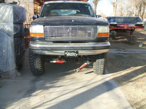 1990 Ford Bronco - Lifted 1992 Ford Bronco front end shows aftermarket shocks and a custom license plate.