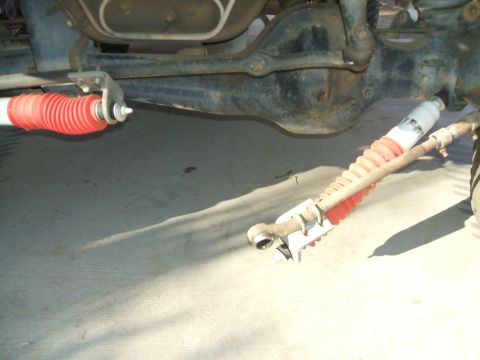 1990 Ford Bronco - This photo shows the rear axle and suspension components of a vehicle, including shock absorbers with red bellows.
