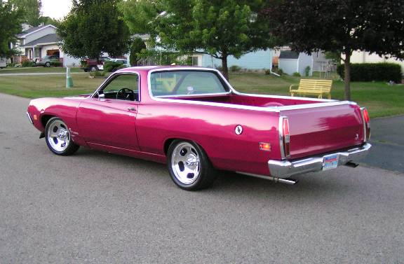 Pink Ford Ranchero parked on a residential street, rear quarter view