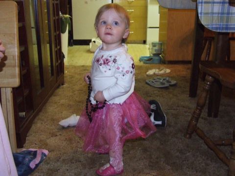 1990 Ford Bronco - A young child dressed in a sparkly pink tutu and a floral shirt stands in a room.