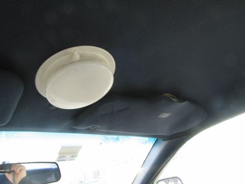 1991 Ford LTD Crown Victoria - The interior of a car shows a dome light and a sun visor.