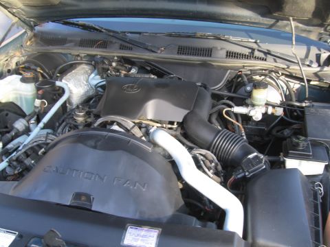 1991 Ford LTD Crown Victoria - The engine bay of a 1991 Ford Crown Victoria LTD is visible, with the V8 engine and various components clearly depicted.