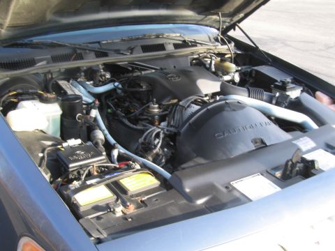 1991 Ford LTD Crown Victoria - Engine bay of a 1991 Ford Crown Victoria LTD, viewed from the front with the hood raised.