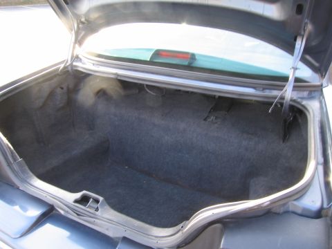 1991 Ford LTD Crown Victoria - The interior of a 1991 Ford Crown Victoria LTD trunk is shown with the lid open.