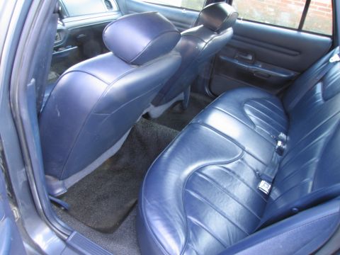 1991 Ford LTD Crown Victoria - Interior view of a 1991 Ford Crown Victoria LTD, showing the rear seats and door panel.
