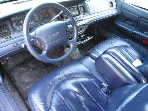1991 Ford LTD Crown Victoria - The interior of a 1991 Ford Crown Victoria LTD features blue leather seats and a matching dashboard.