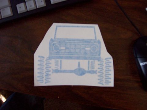 1967 Ford Bronco - A sticker depicting the front end of a 1967 Ford Bronco is shown on a wooden surface.