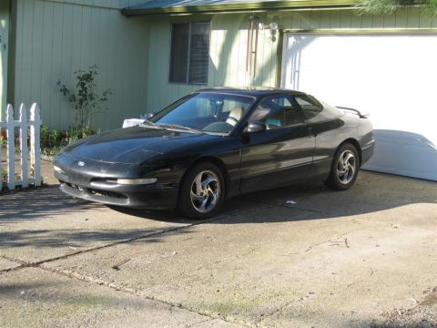 1994 Ford Probe - Black 1994 Ford Probe coupe parked on a concrete driveway next to a garage.