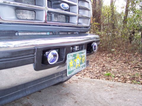 1996 Ford Bronco - Close-up of a Ford truck's front bumper, showing fog lights and a Florida Sheriffs Association license plate.