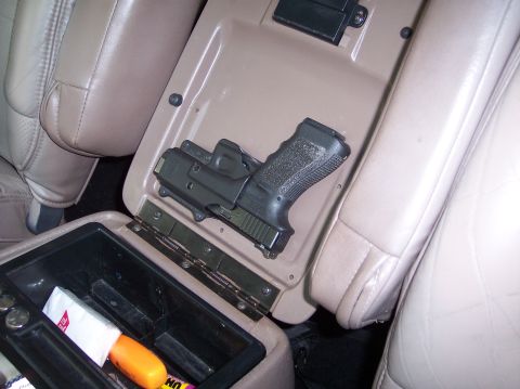 1996 Ford Bronco - The Road Rage Tactical Response Device. I took a little-used holster and attached it with screws to the inside of the center console lid...…
