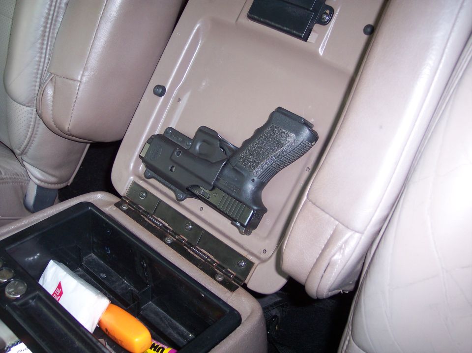 The Road Rage Tactical Response Device. I took a little-used holster and attached it with screws to the inside of the center console lid...yes, I have a permit for it