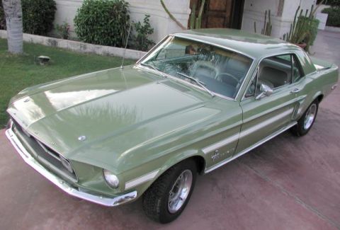 1978 Ford Mustang II - This green coupe features distinctive white side stripes and a classic design.