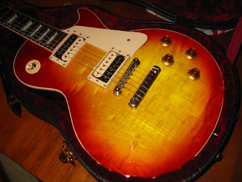 1989 Mazda MX-6 - Close-up of a sunburst electric guitar with chrome hardware, resting in its case.