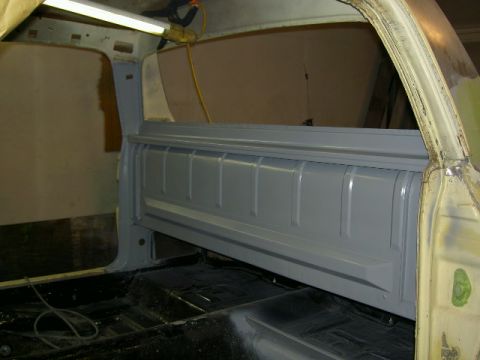 1967 Ford Ranchero - The interior of a pickup truck bed shows gray paneling and a black floor, possibly undergoing restoration.